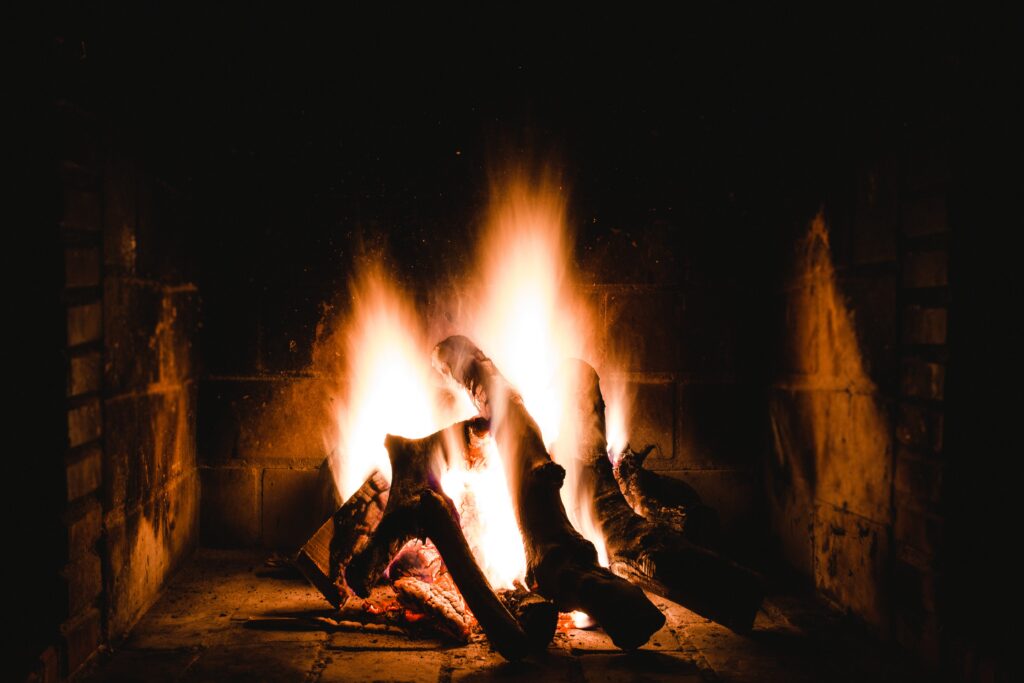 Photo of Lighted Firewoods in Dark Place